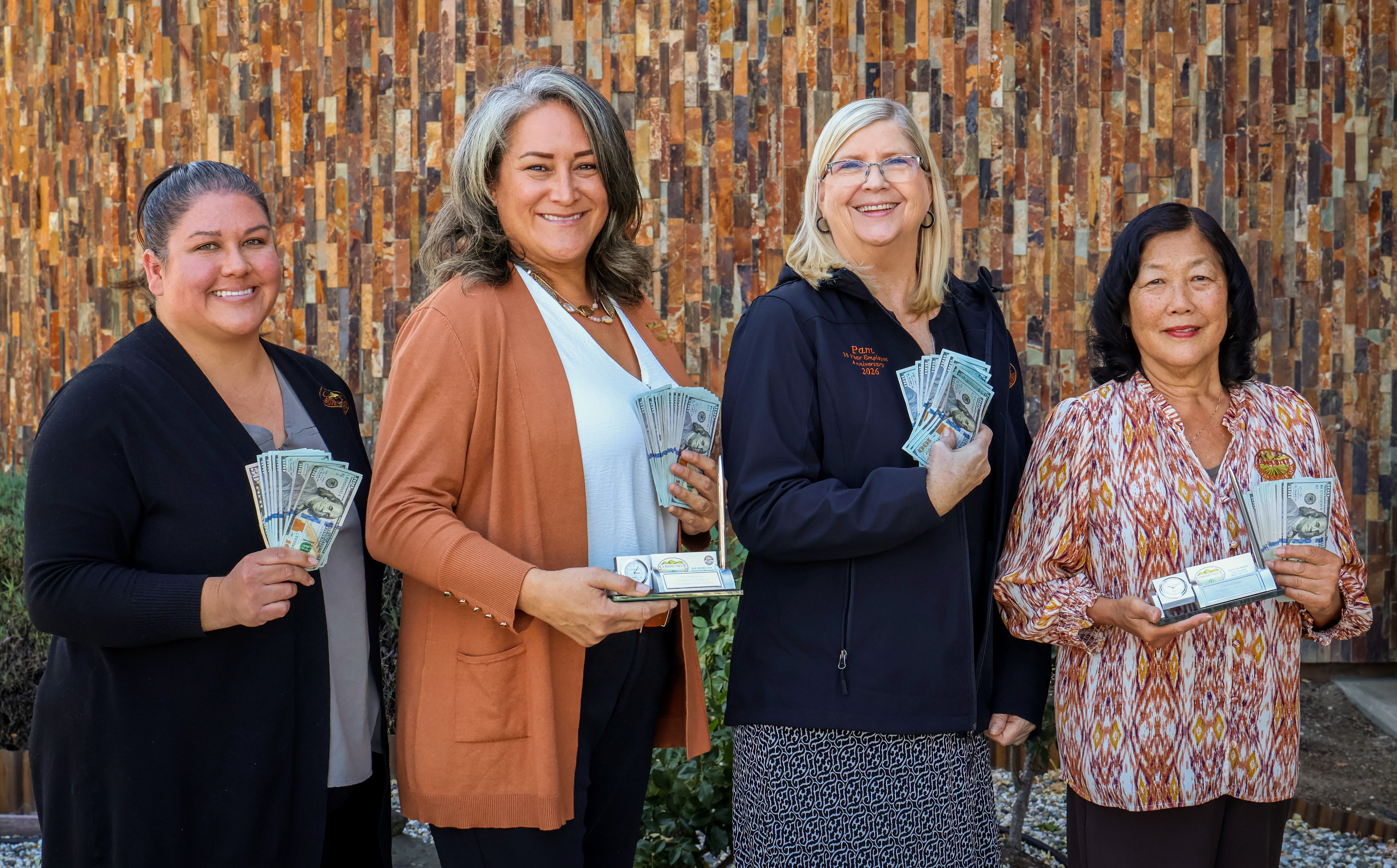 Photo of employees holding various items